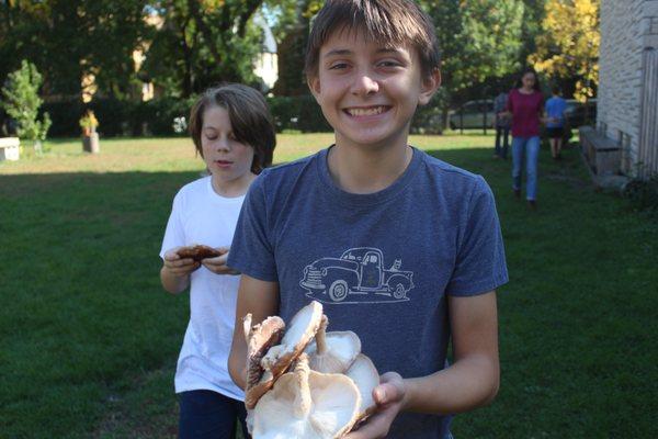 Jack celebrates the first harvest of shitake mushrooms from the middle school's log-grown crop.