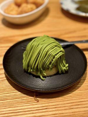 Matcha mon-buran - soft sponge cake topped whipped cream with hidden red bean in the center and covered with strands of green tea cream