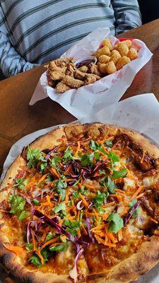 Spicy Thai chicken pizza and steak fingers with tots