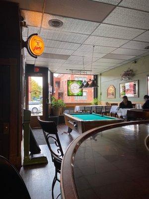 Pool and tables in the front of the bar.