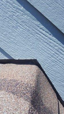 Gap between siding and roof, no flashing.  Exposed to snow/rain.