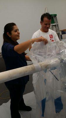 Classmates trying simulation glove bag containment.