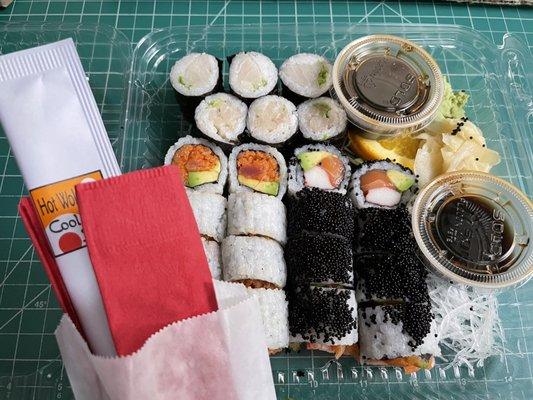 Negi Hamachi, Spicy Tuna, Alaskan Maki rolls, and elegant cutlery.