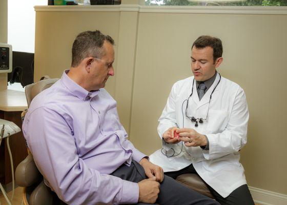 Dr. Daniel Ardelean helping a patient