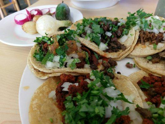 7 tacos with an extra side of grilled and fresh vegetables