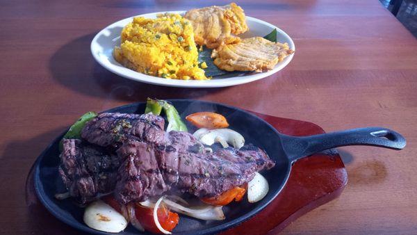 Skirt steak with veggies, yellow rice and plantains. Make sure to get the sauce.