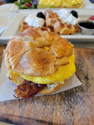 Scrambled eggs & bacon on a croissant