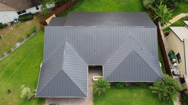 North Side of Property. 24 Gauge, Galvanized Steel, Standing Seam, with a Dark Bronze finish for the color.