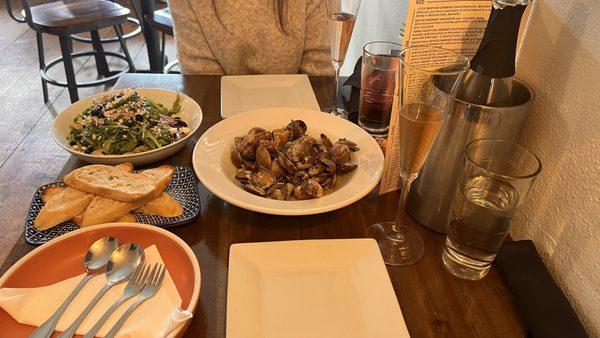 Steamed mantilla clams in citrus white wine sauce, toast points and arugula salad