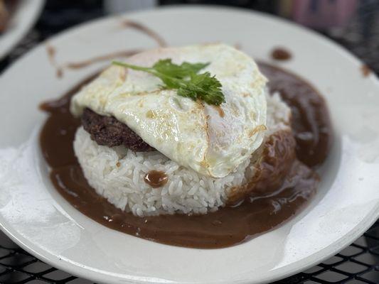 Loco moco with steamed rice, hamburger, and an over easy egg.