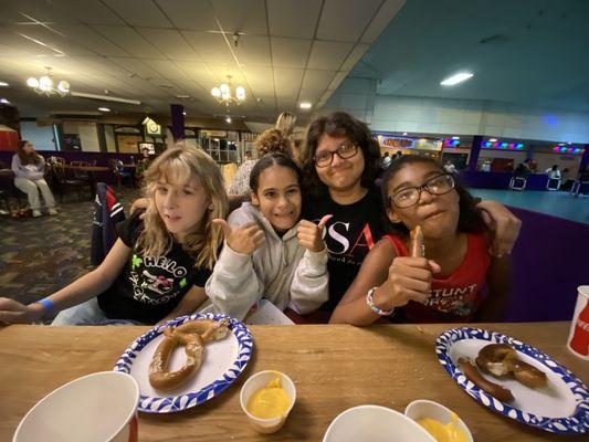 My kid and her friends. Eating pretzel with cheese.