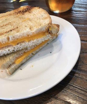 Grilled cheese entree. Very sparse cheese. Notice how it doesn't go to the edge of the bread?