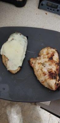 Boneless skinless chicken breast cooked over charcoal.  Left one has melted provolone on top.  They have a great meat and produce selection