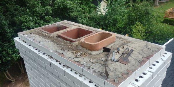 Improper masonry crown...easily allows water to enter the top of the chimney.