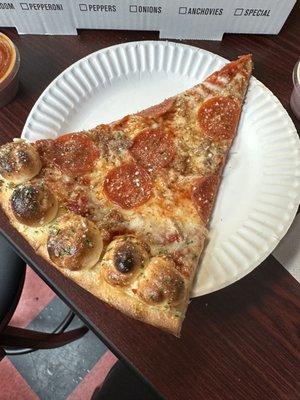 Garlic knot pizza with pepperoni and sausage