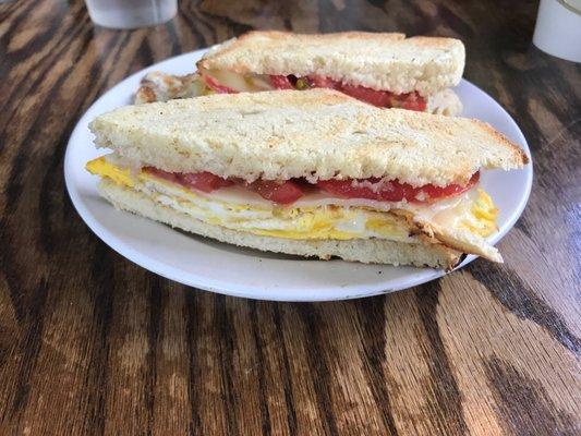 Sesame baguette with egg cheese and heirloom tomatoes (all local and amazing!)