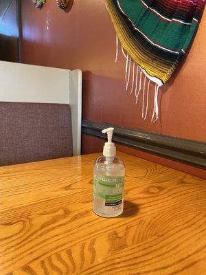 Hand sanitizer dispenser on each table