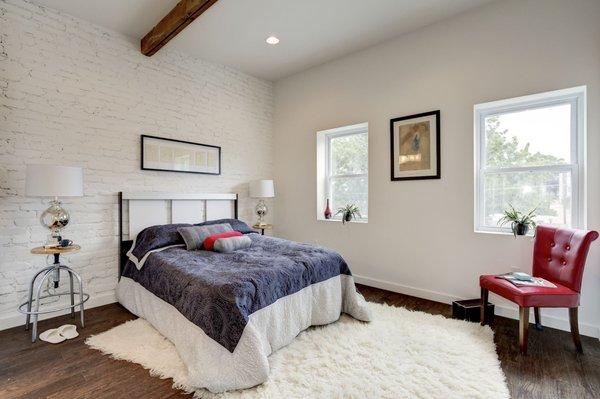 Master Bedroom with vaulted ceilings and exposed wood beam.