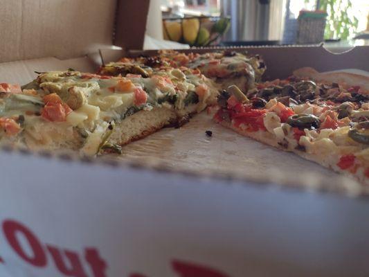 Detroit style pizza on the left, thin crust on the right. Detroit is about three times thicker.