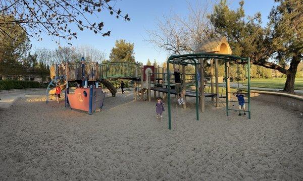 Cute playground with sand all around. Lots of sand toys to play with. A couple big kid swings as well.