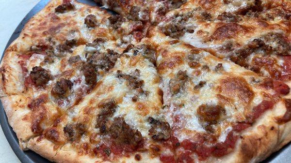 Sausage pizza with homemade Dough, Sauce, and Fresh made Italian Sausage.