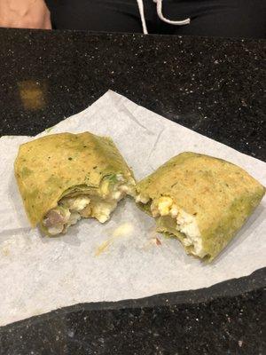 Delicious monster egg with avocado and turkey wrap in spinach wrap