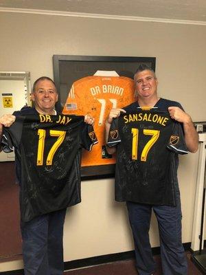 Dr. Heintz and Dr. Sansalone show off Dynamo jerseys.  Our doctors are the treating chiropractors for the Dynamo and Dash for 2018-2019!