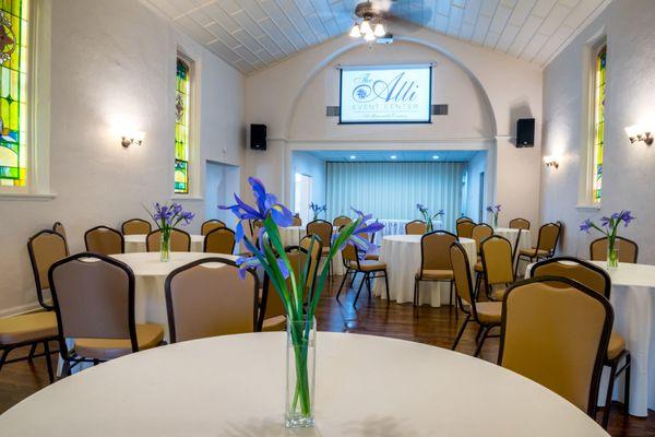 Inside the venue space complete with beautiful stained glass windows and capacity for 80 guests!