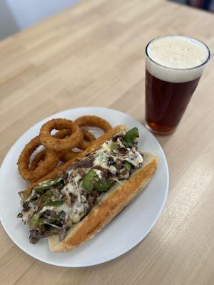 The gunny draft from bravery brewing and a Philly cheesesteak.