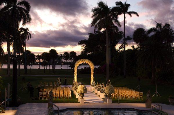 Outside wedding at the pool and lawn at The Mar A Lago Club in Palm Beach, Florida