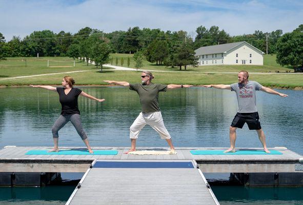 Members doing yoga on the dock at Sana Lake Recovery rehab center near St. Louis, MO