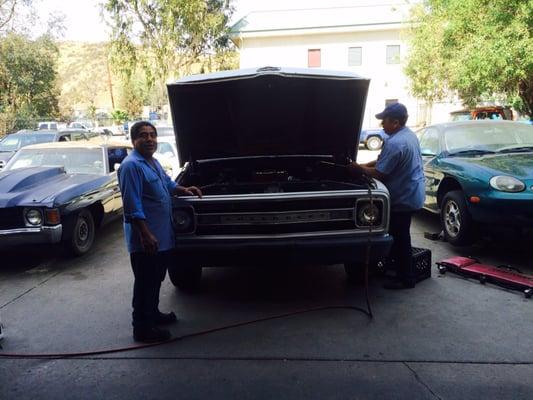 Socrates (left) and Hugo (right). Both working on a 1969 chevy c20.