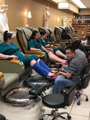 Customers enjoy pedicure spa after a long day at work.