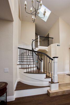 Impressive curved fitting with solid white oak treads and SC10 post with iron balusters and curved scrolls