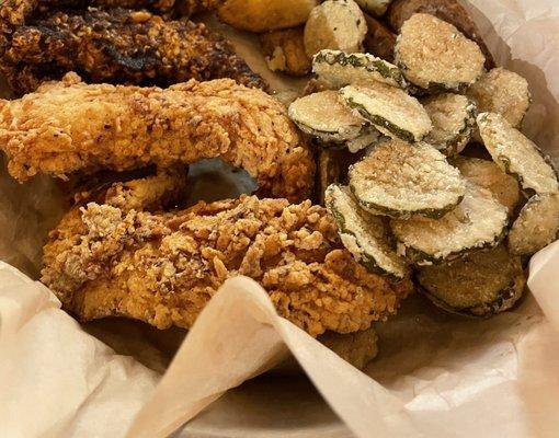 Chicken tenders, fried pickles and potato wedges.