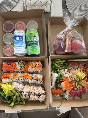 Complimentary treats on top  Bottom left: Rainbow roll ($15.95), California roll ($8.95), Crab salad roll Bottom right: Chirashi ($24.95)