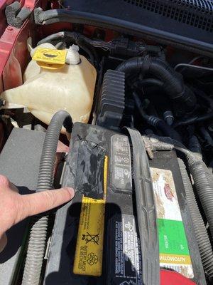 Electrical tape over battery.