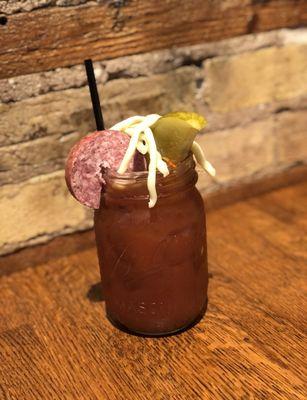 Blood Mary with local summer sausage, local cheese, pickle and olives.