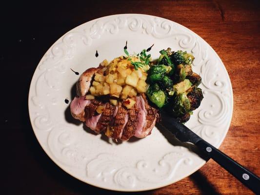 Seared Duck Breast, apple chutney and pumpkin spoon bread, Brussels sprouts.