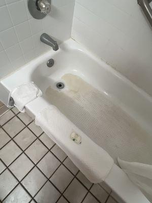 Filthy tub with previously used towel