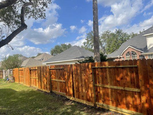 Western Red Cedar picket fence with 2x6 rot board, and clear water sealer. Good neighbor style.