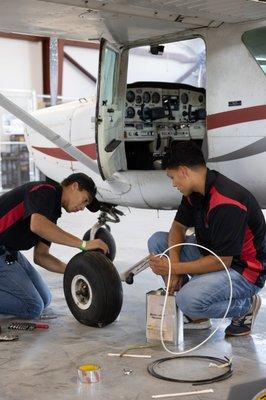 AMT students changing tire