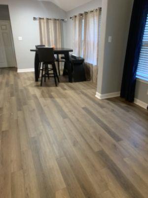 Installed NEW Flooring and upgraded baseboards gives house a new look.