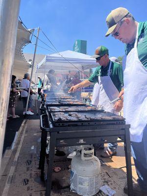 Tracy and Marvin flipping burgers.