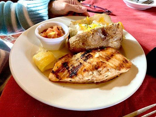 Grilled salmon with lemon, mango avocado salsa and baked potato.