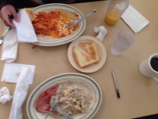 Eggs, hash browns, bread, ham, biscuits & gravy, OJ, coffee