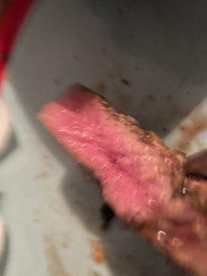 Bloody filet with tendons running through it. Can barely cut it and cannot chew it.