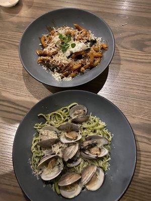 top: some kind of red sauce pasta with lamb bottom: pesto fettuccine with clams