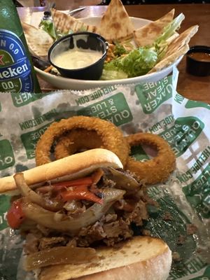 Cheesesteak with onion rings.  Chicken tender salad.