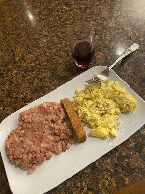 The warm breakfast served from 7-10am Corned beef hash, scrambled eggs, and a French toast stick